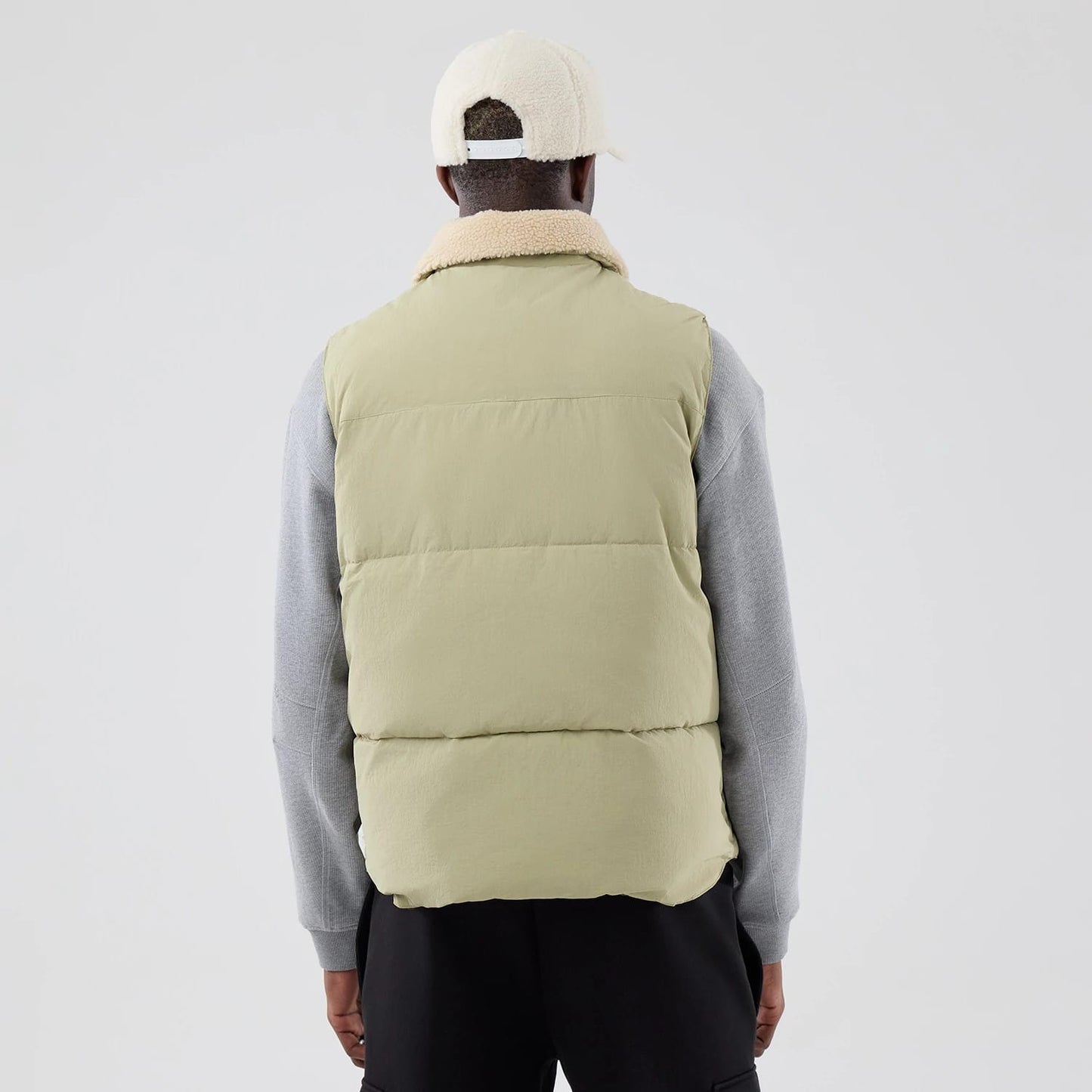 The Male model is wearing  New Era Organic Boa Neck Khaki Gilet 2