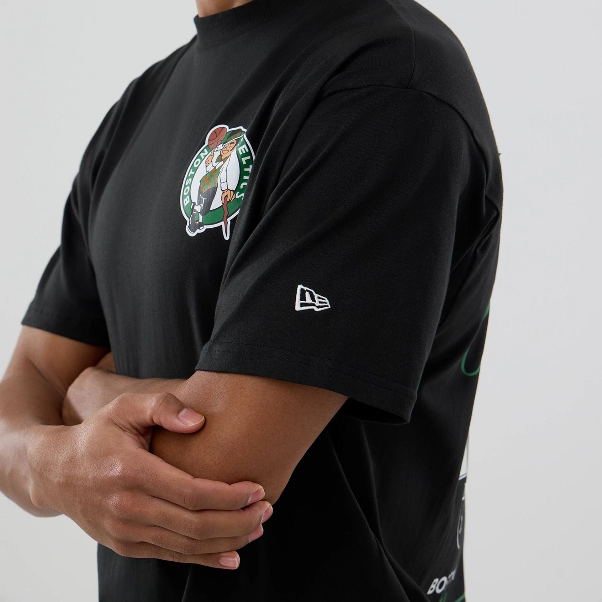 The model is wearing this NBA logo Boston Celtics T-Shirt in black. 5