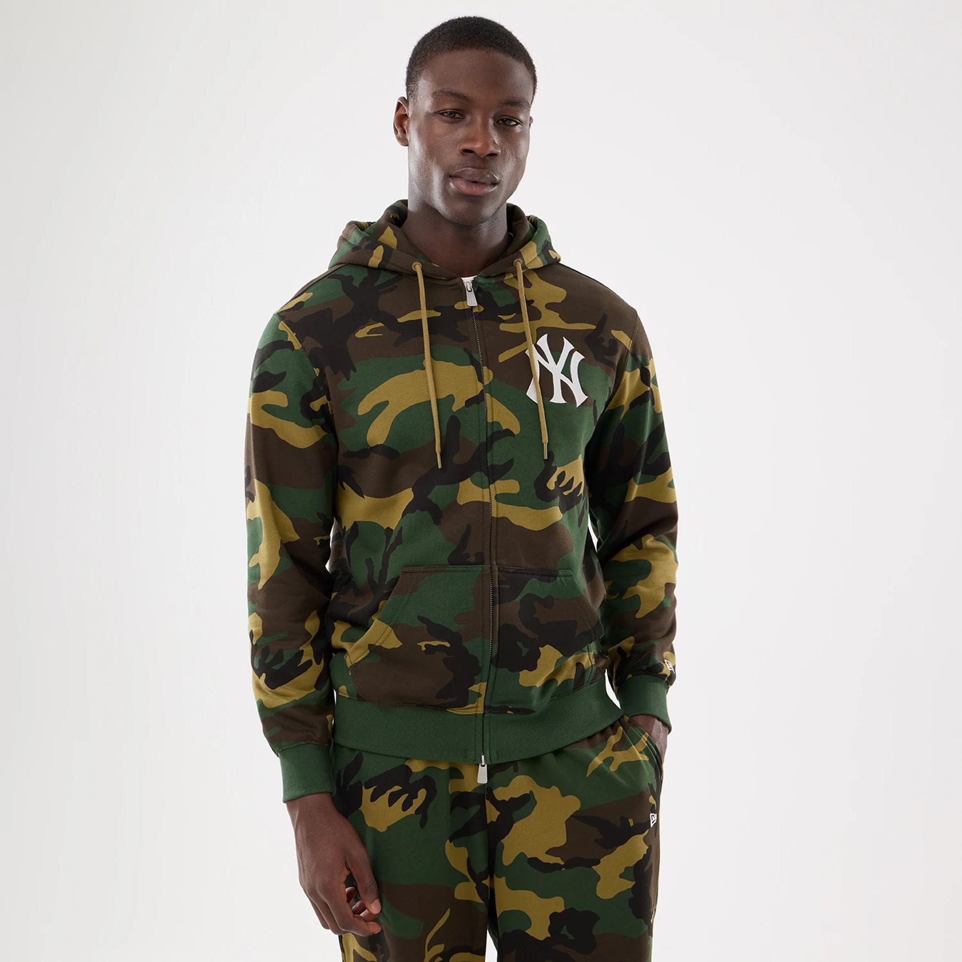 The model is wearing this MLB Camo New York Yankees 2 Way Full Zip Hoodie in Woodland Camo. 1