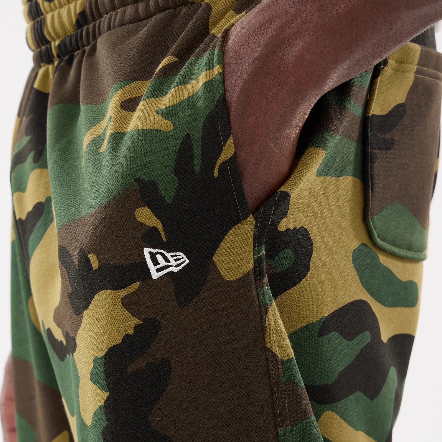 The model is wearing this New Era Woodland Camo Joggers in Woodland Camo. 3