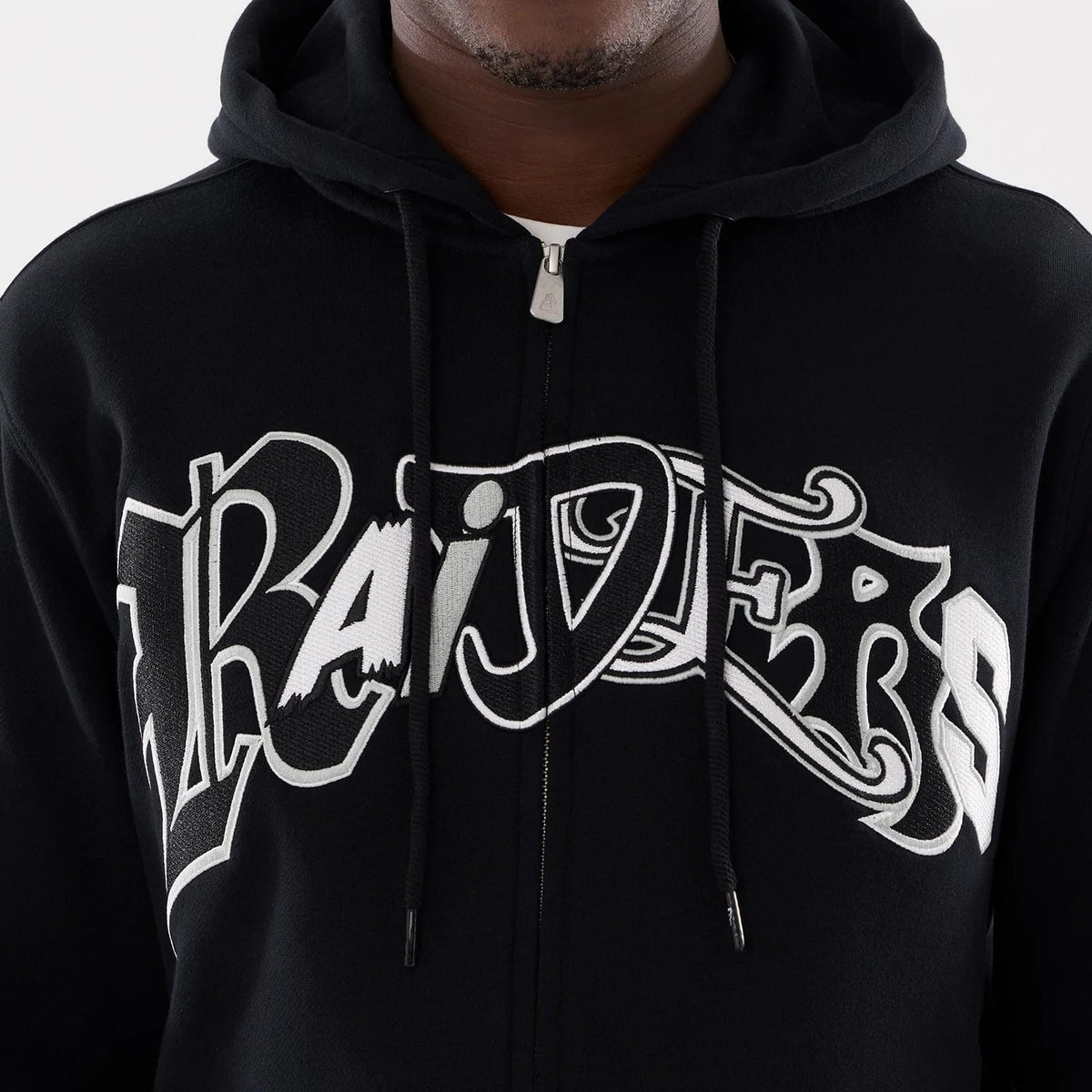 The model is wearing this MLB Word Art Las Vegas Raiders 2 Way Full Zip Hoodie in black. 4