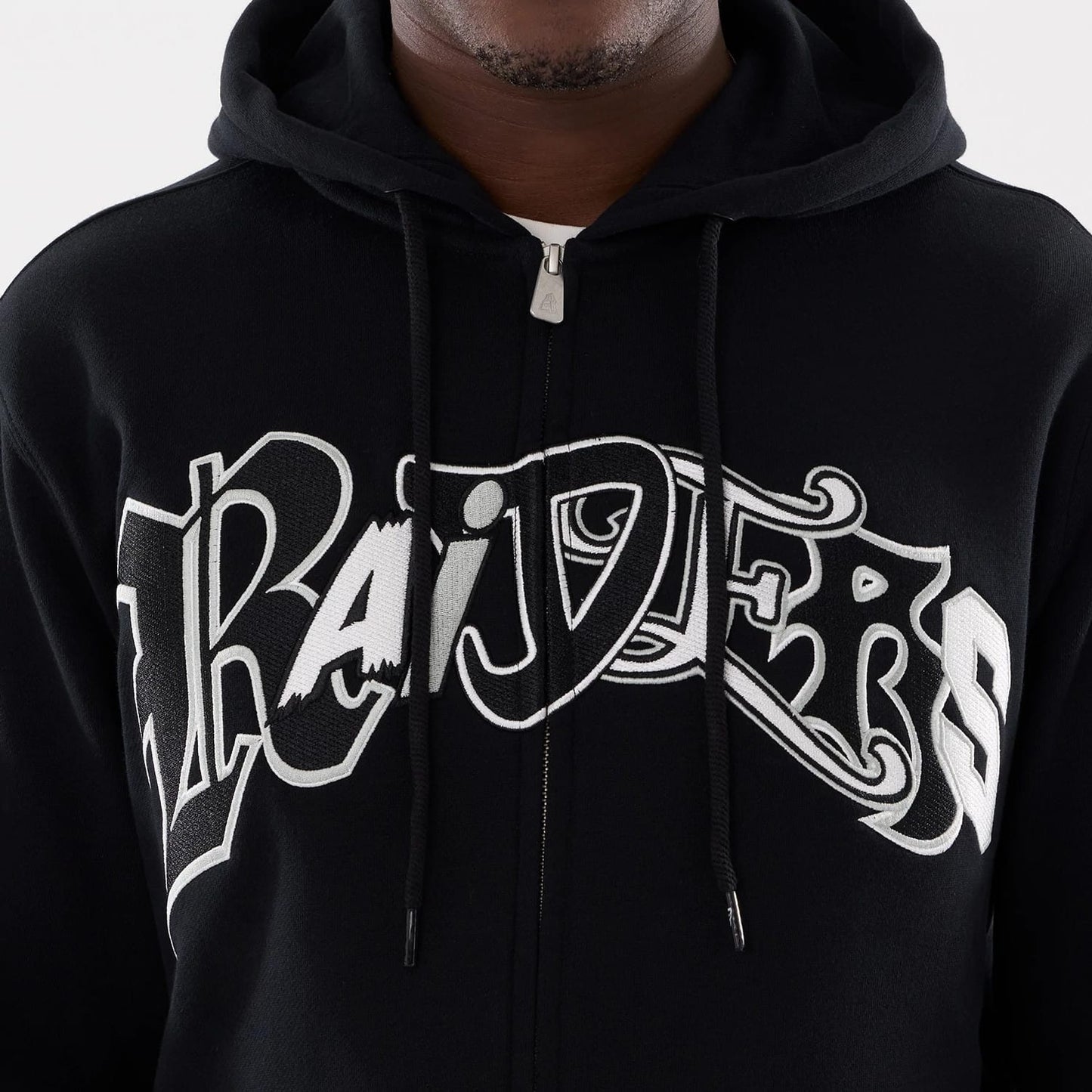 The model is wearing this MLB Word Art Las Vegas Raiders 2 Way Full Zip Hoodie in black. 4
