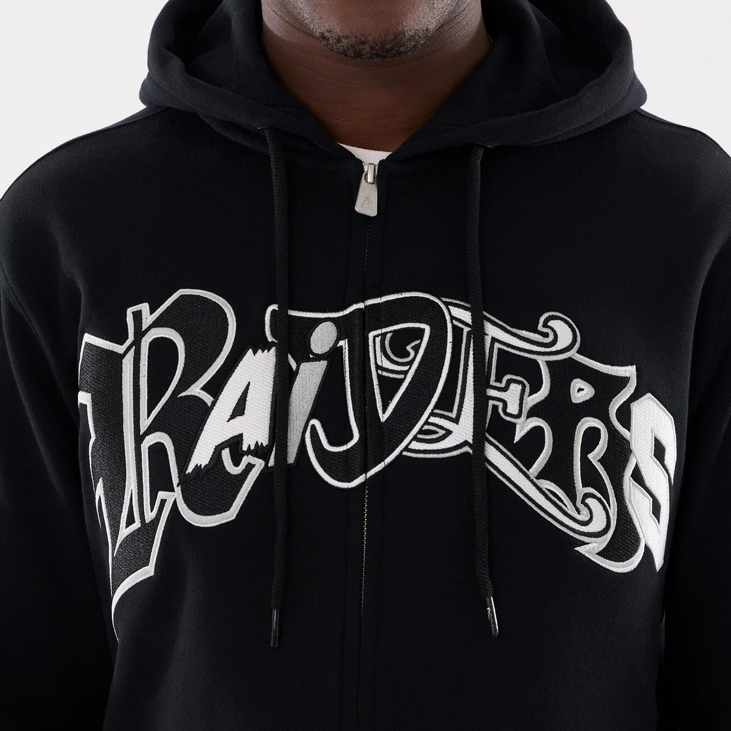 The model is wearing this MLB Word Art Las Vegas Raiders 2 Way Full Zip Hoodie in black. 4