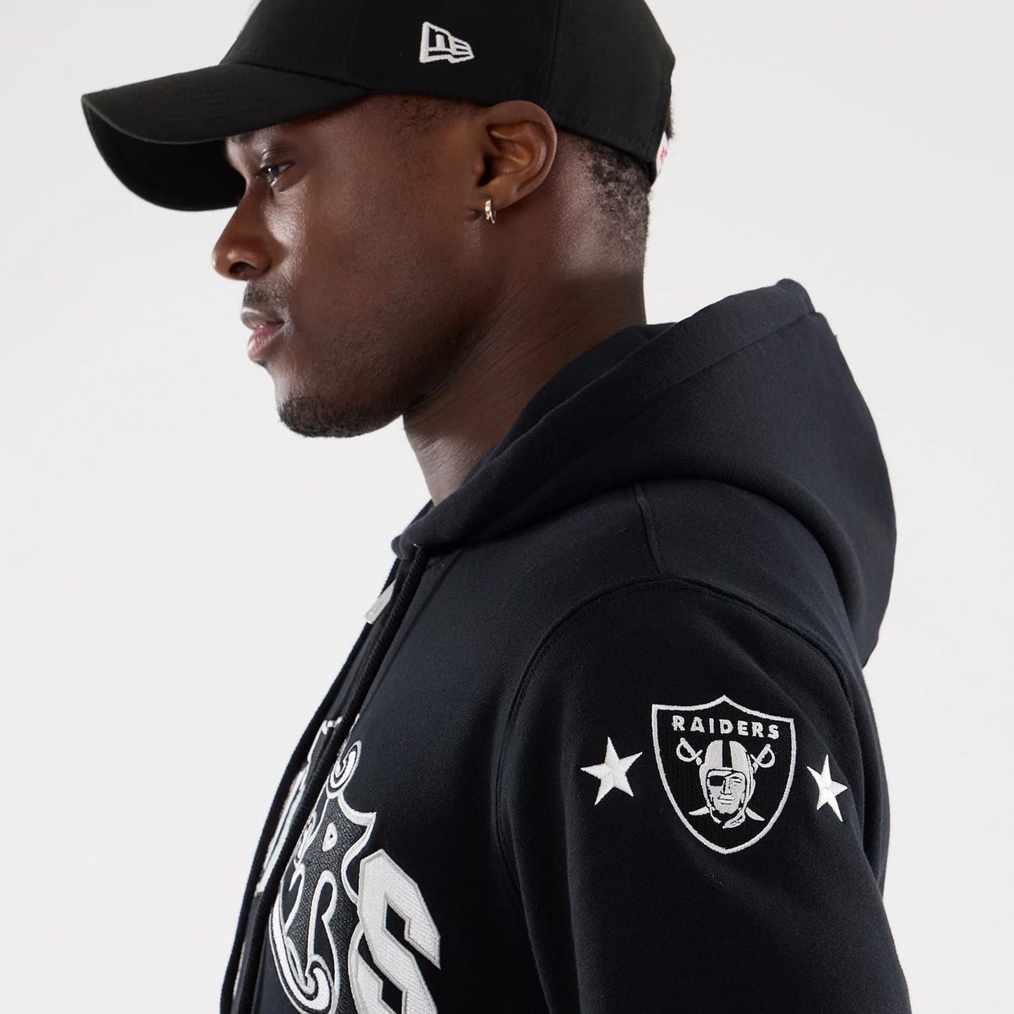 The model is wearing this MLB Word Art Las Vegas Raiders 2 Way Full Zip Hoodie in black. 7