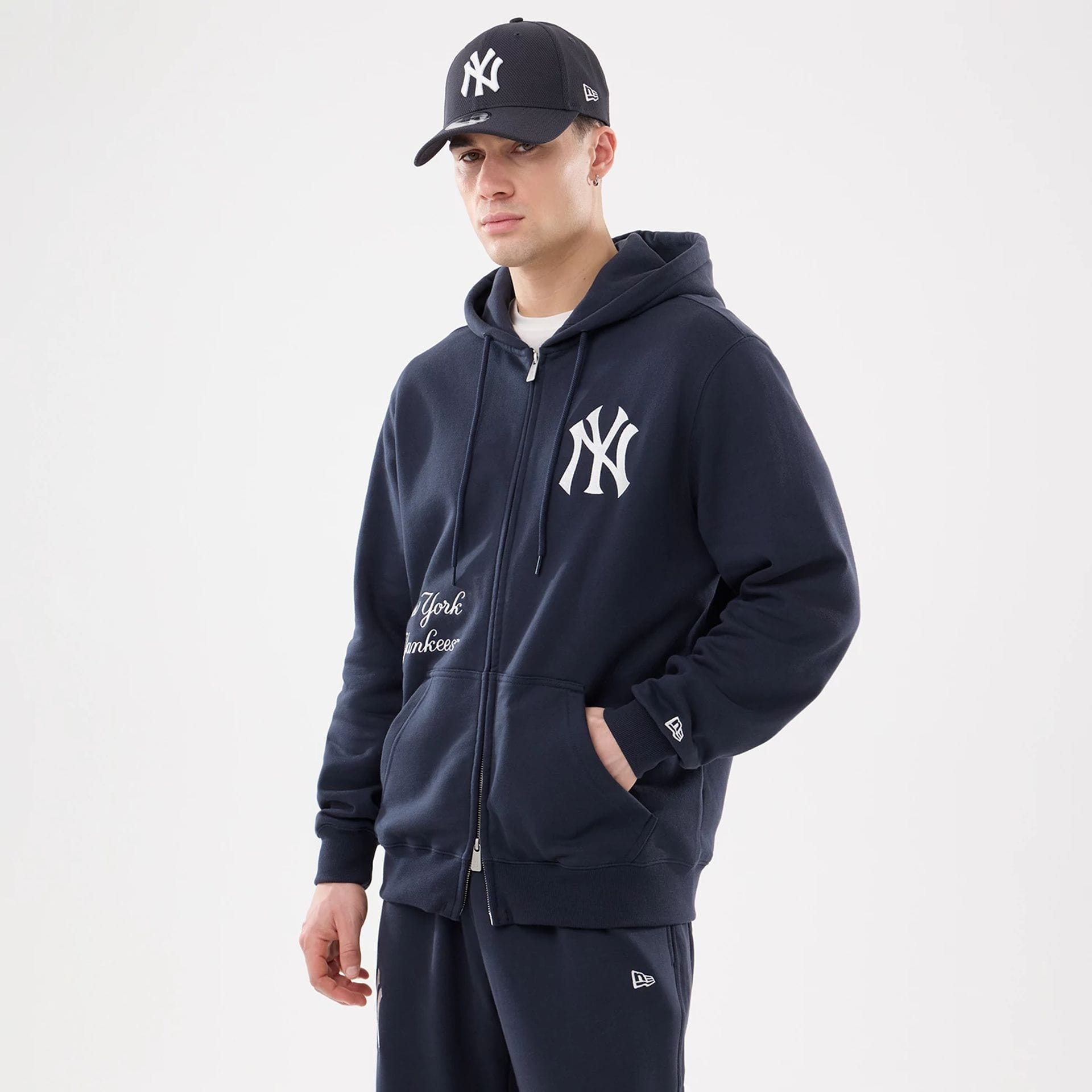 The model is wearing this MLB Comfort New York Yankees 2 Way Full Zip Hoodie in navy. 1