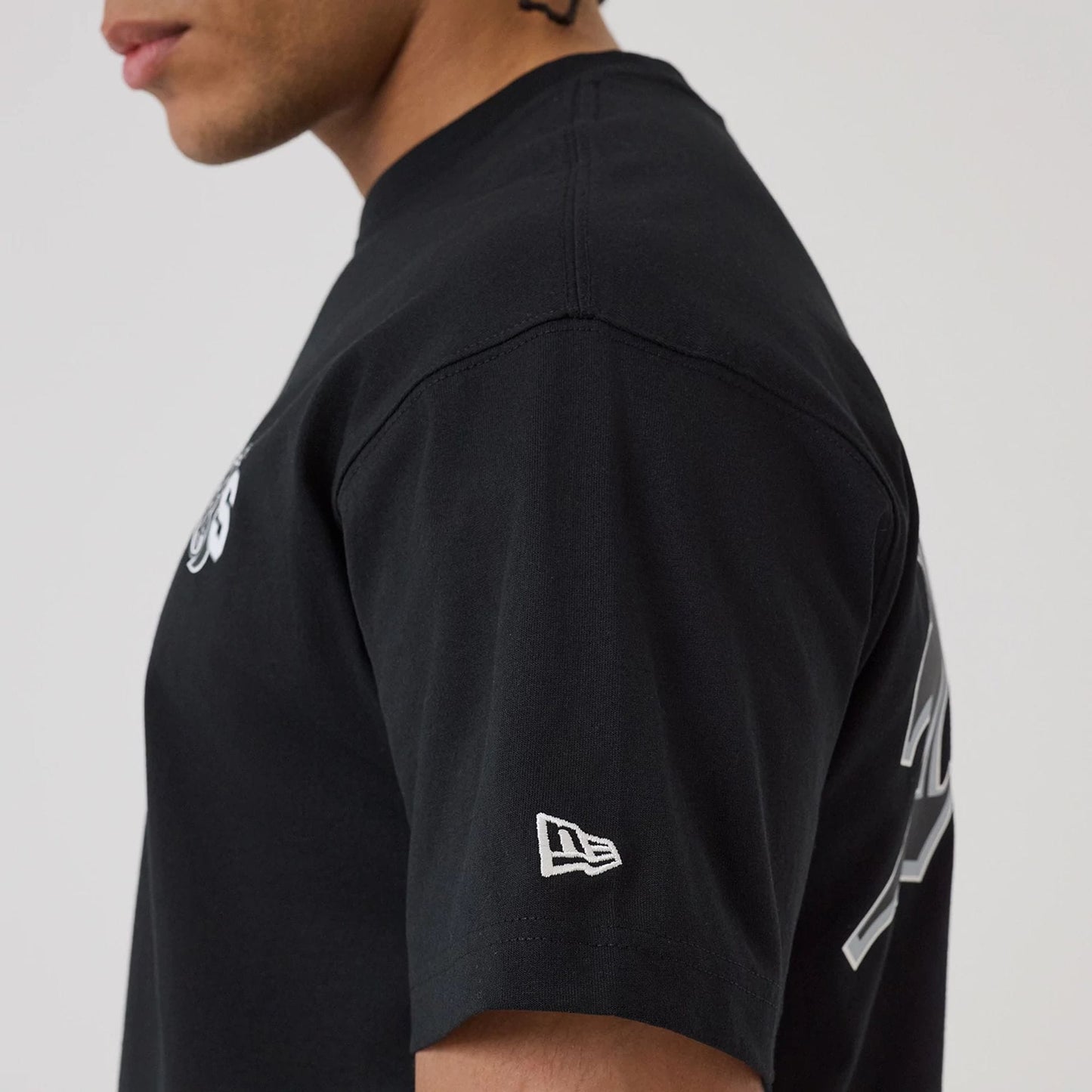 The model is wearing this NFL Word Art Las Vegas Raiders T-Shirt in black. 6