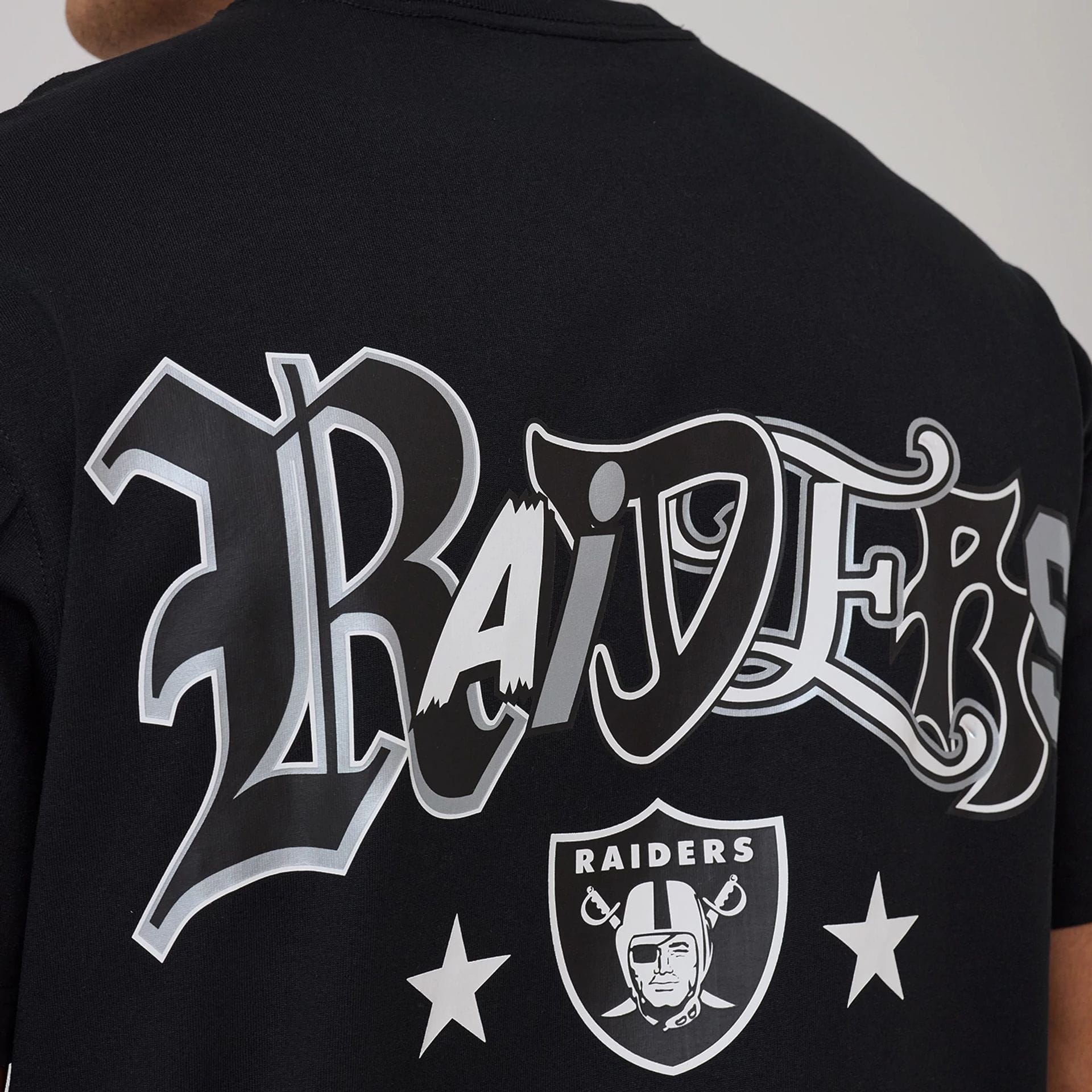 The model is wearing this NFL Word Art Las Vegas Raiders T-Shirt in black. 4
