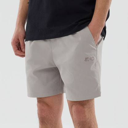The model is wearing this New Era NEC Logo Oversized Shorts in Beige . 3