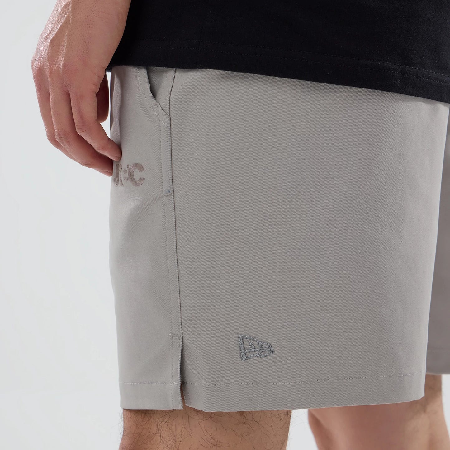 The model is wearing this New Era NEC Logo Oversized Shorts in Beige . 4