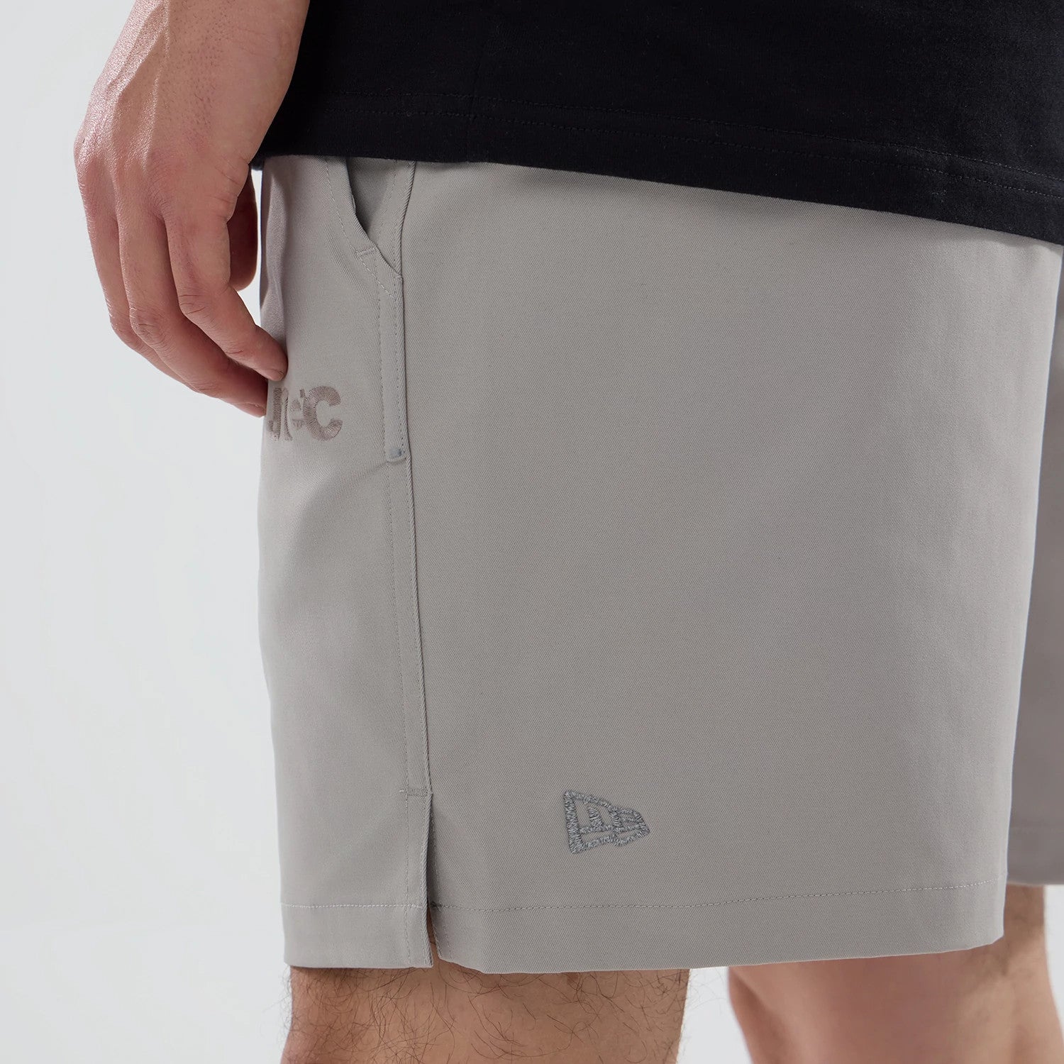 The model is wearing this New Era NEC Logo Oversized Shorts in Beige . 4
