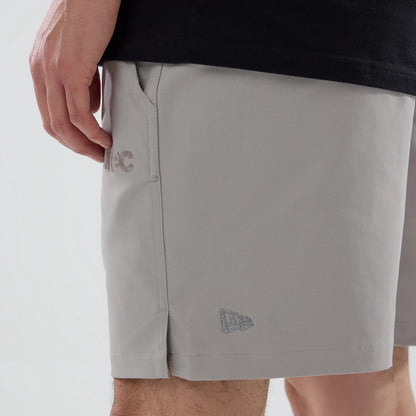 The model is wearing this New Era NEC Logo Oversized Shorts in Beige . 4