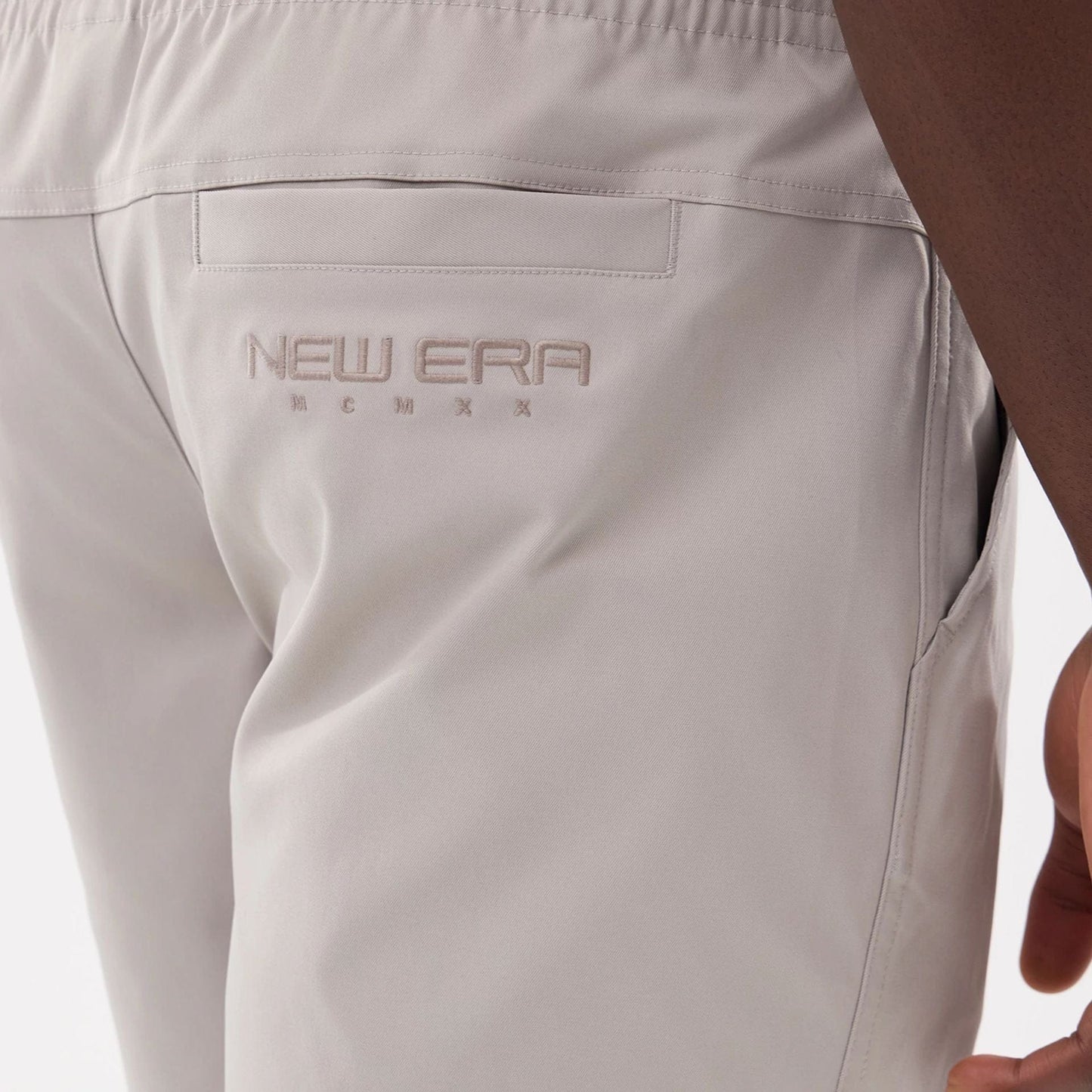 The model is wearing this New Era NEC Logo Oversized Shorts in Beige . 6