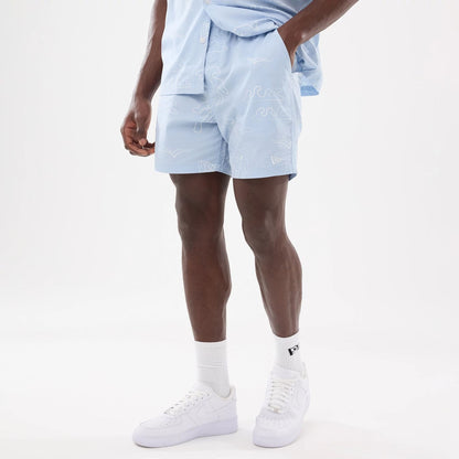 The model is wearing these New Era Resort Oversized Shorts in blue. 8