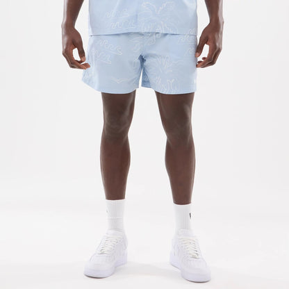 The model is wearing these New Era Resort Oversized Shorts in blue. 1