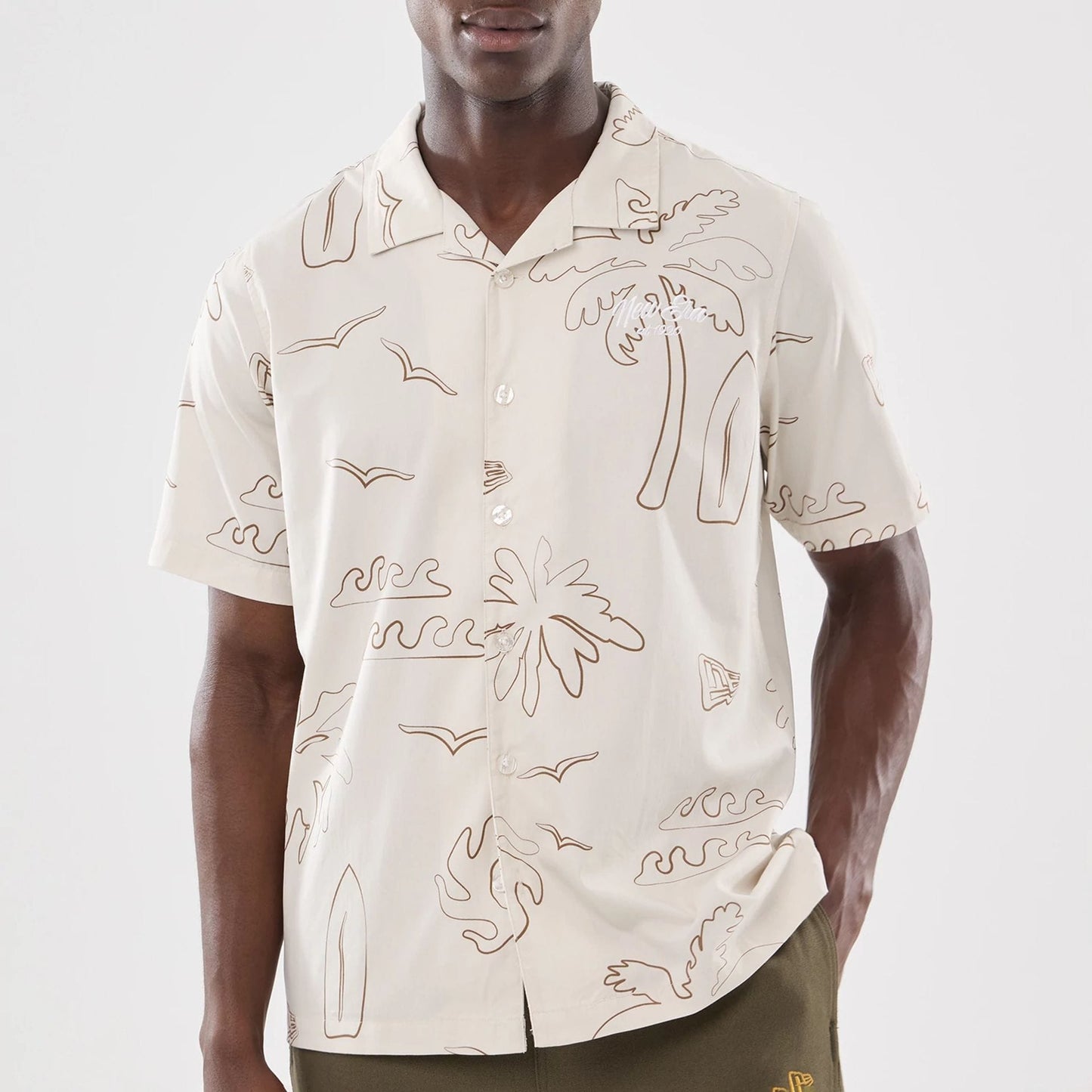 The model is wearing this New Era Resort Short Sleeve Shirt in natural. 6