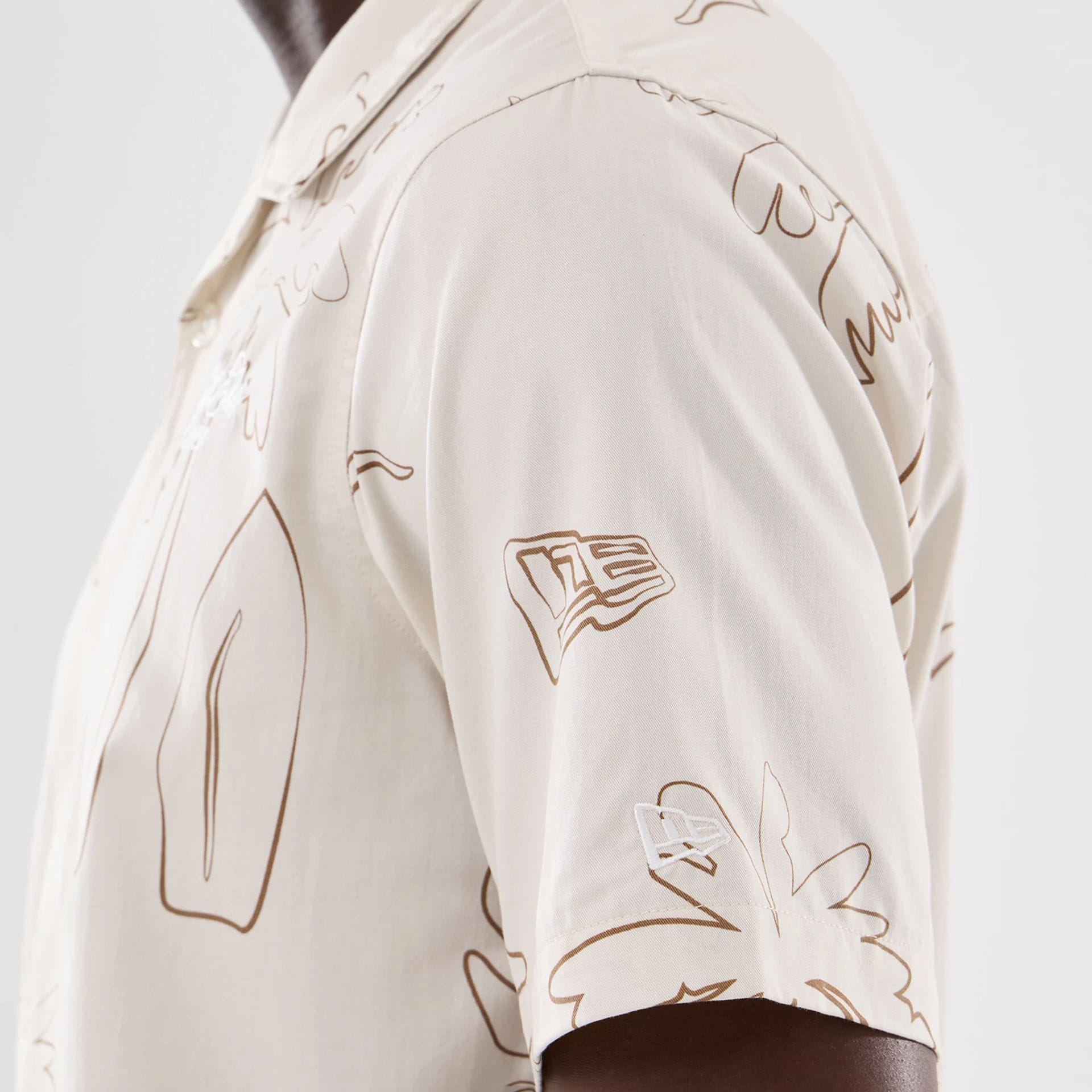 The model is wearing this New Era Resort Short Sleeve Shirt in natural. 4