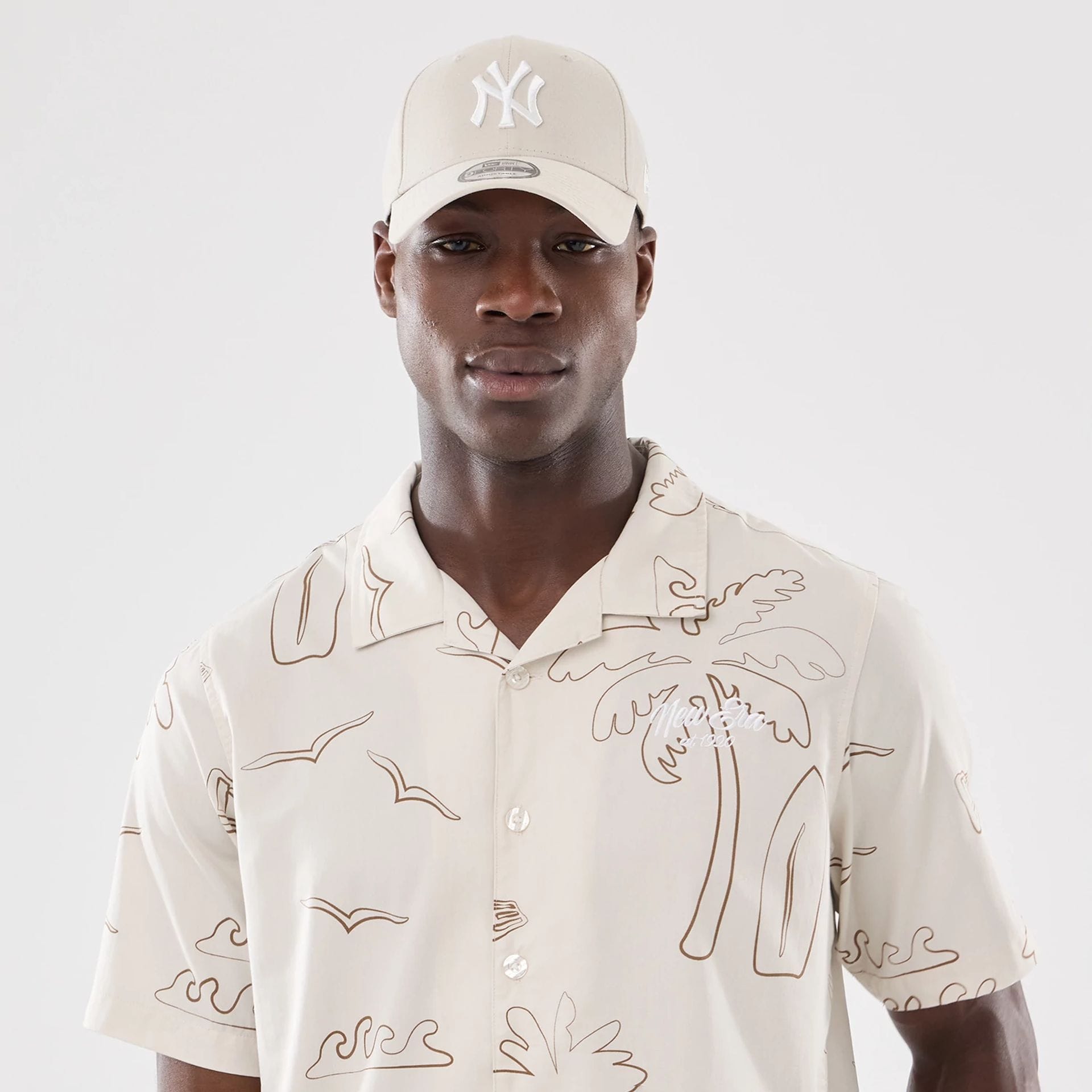 The model is wearing this New Era Resort Short Sleeve Shirt in natural. 7