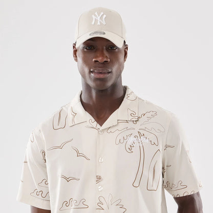 The model is wearing this New Era Resort Short Sleeve Shirt in natural. 7