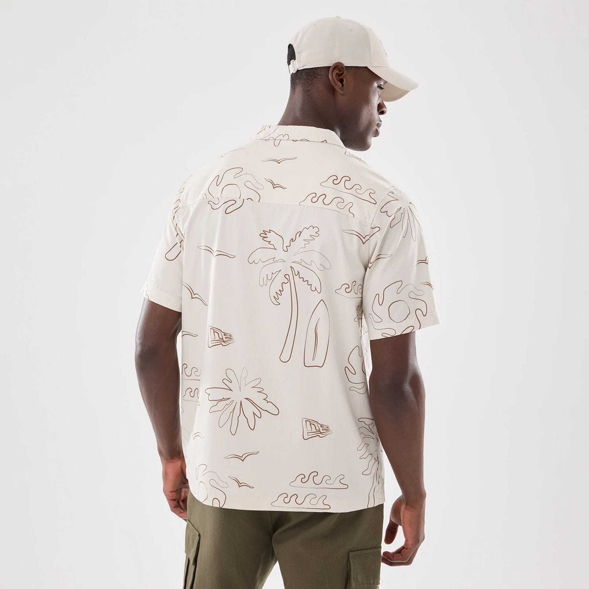 The model is wearing this New Era Resort Short Sleeve Shirt in natural. 2