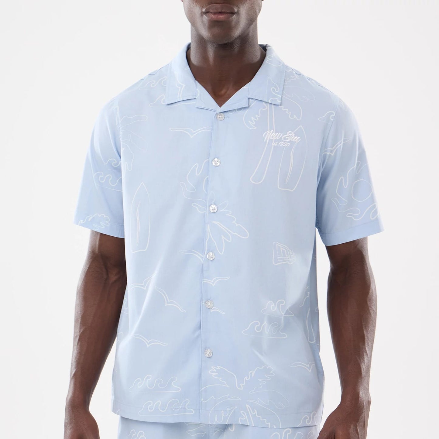The model is wearing this New Era Resort Short Sleeve Shirt in blue. 3