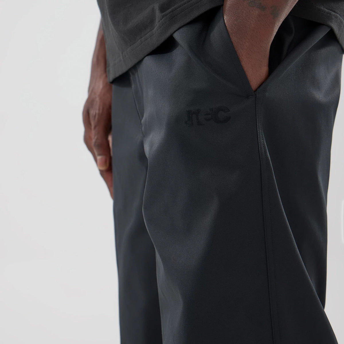 The model is wearing this New Era NEC Logo Straight Leg Joggers in black. 3