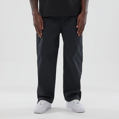 The model is wearing this New Era NEC Logo Straight Leg Joggers in black. 1