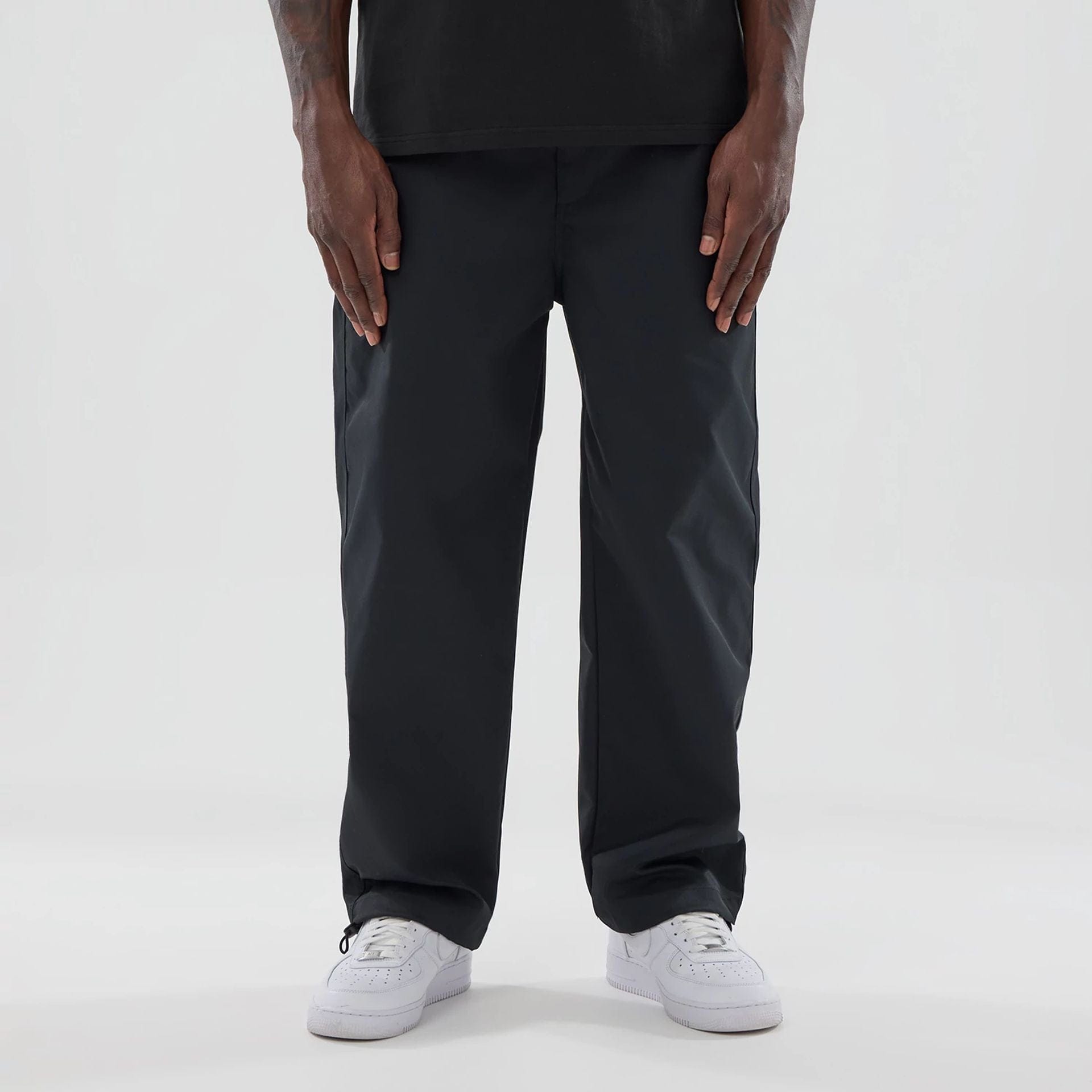 The model is wearing this New Era Urban Core Straight Leg Joggers in black. 1