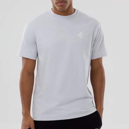 The model is wearing this New Era Zodiac Sign T-Shirt in silver. 4