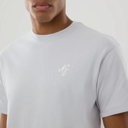 The model is wearing this New Era Zodiac Sign T-Shirt in silver. 5