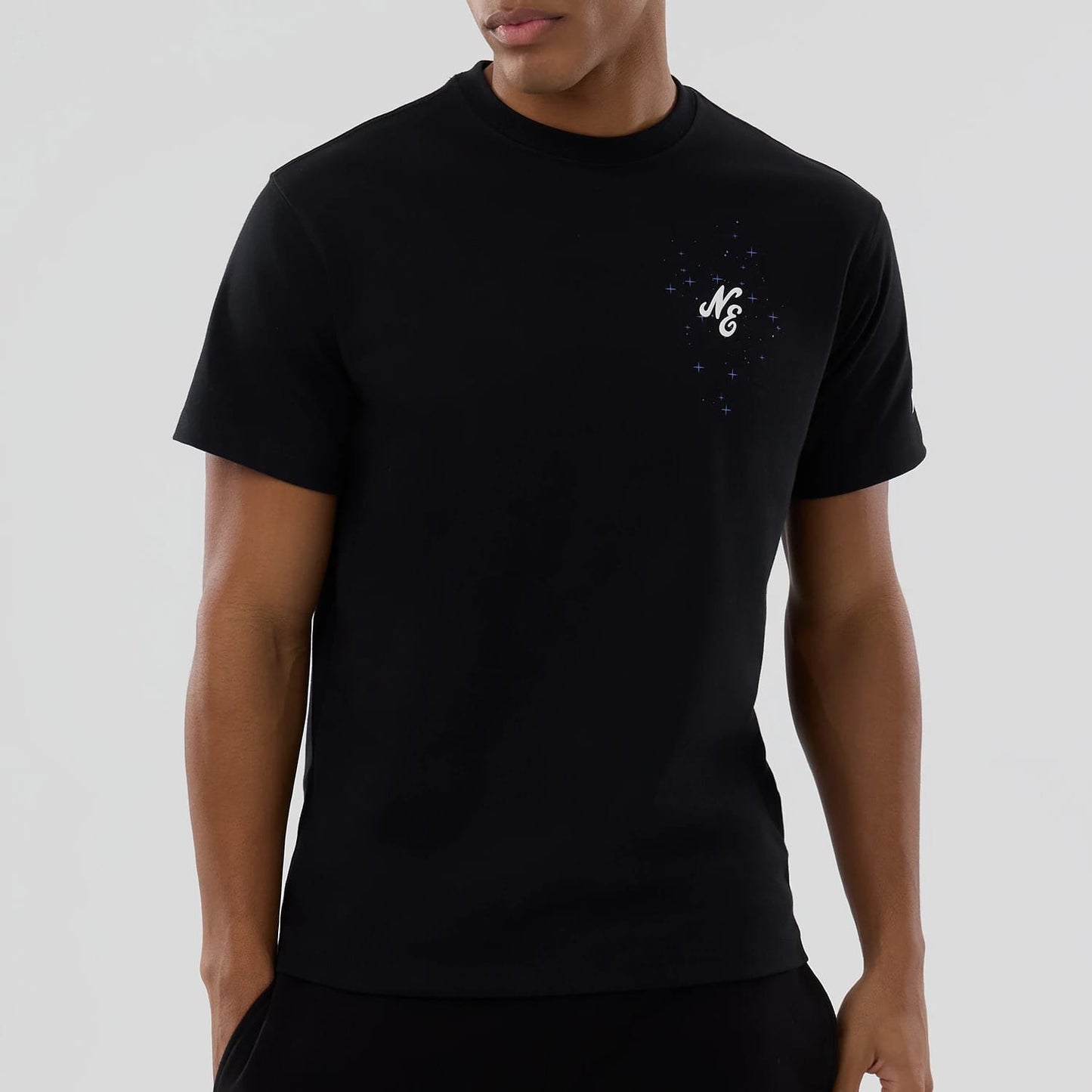 The model is wearing this New Era Zodiac Sign T-Shirt in black. 4
