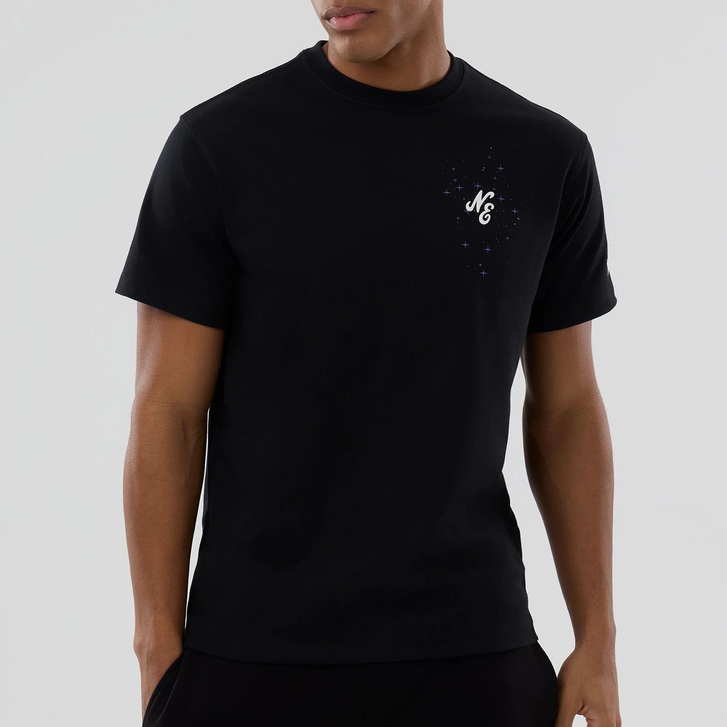 The model is wearing this New Era Zodiac Sign T-Shirt in black. 4