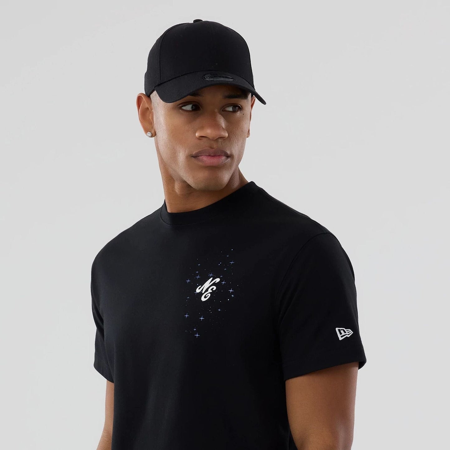 The model is wearing this New Era Zodiac Sign T-Shirt in black. 7