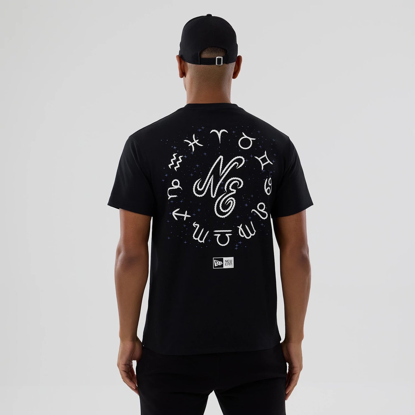 The model is wearing this New Era Zodiac Sign T-Shirt in black. 2