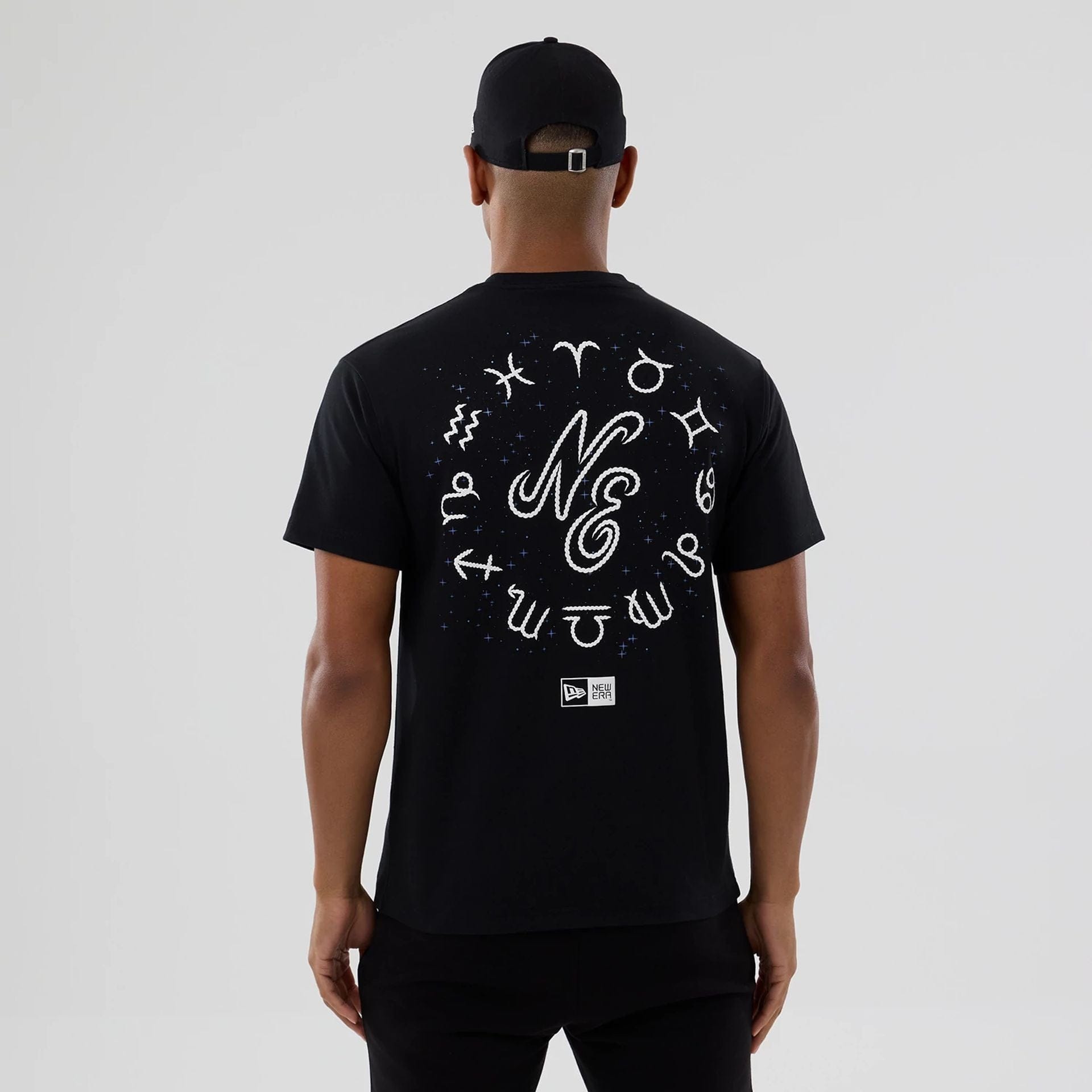 The model is wearing this New Era Zodiac Sign T-Shirt in black. 2