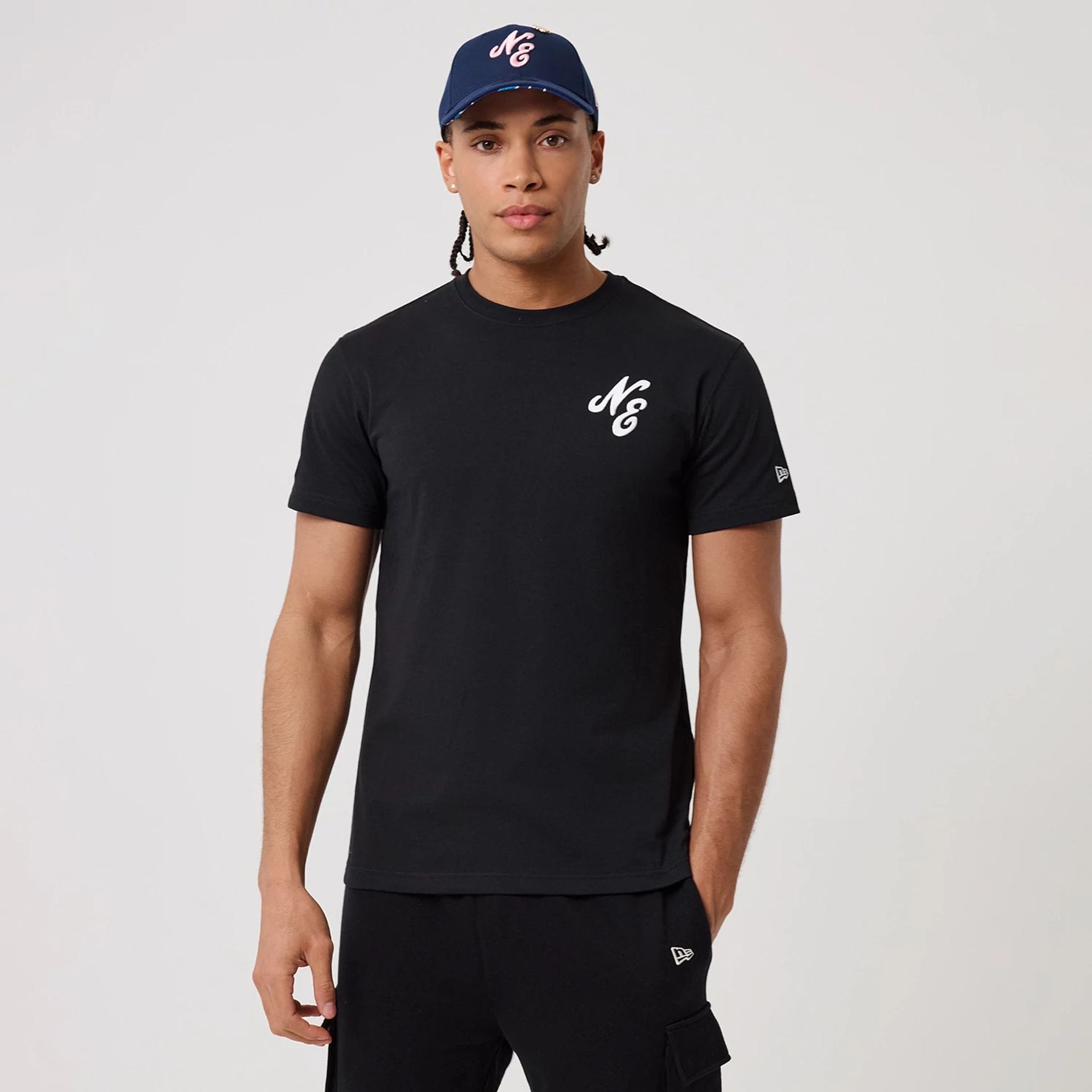 The model is wearing this New Era Sakura T-Shirt in black. 1