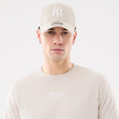 The model is wearing this New Era Resort T-Shirt in natural. 7