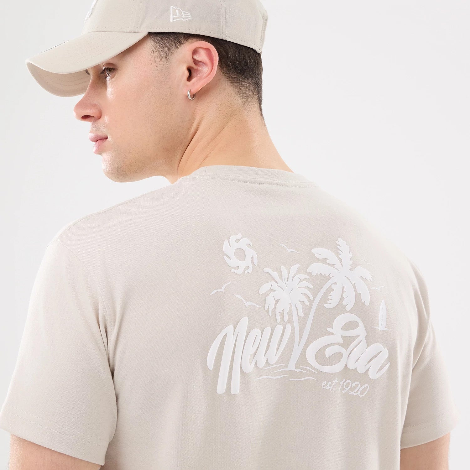 The model is wearing this New Era Resort T-Shirt in natural. 4