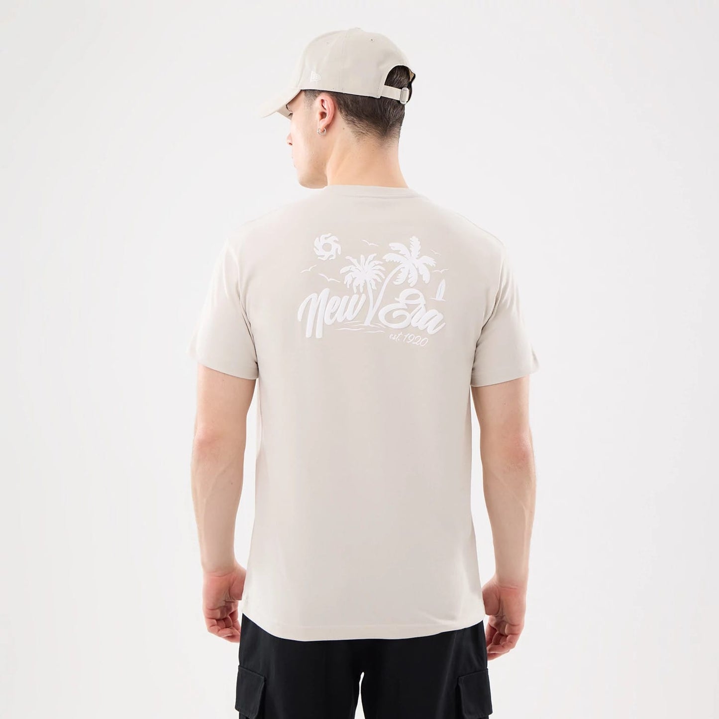The model is wearing this New Era Resort T-Shirt in natural. 2