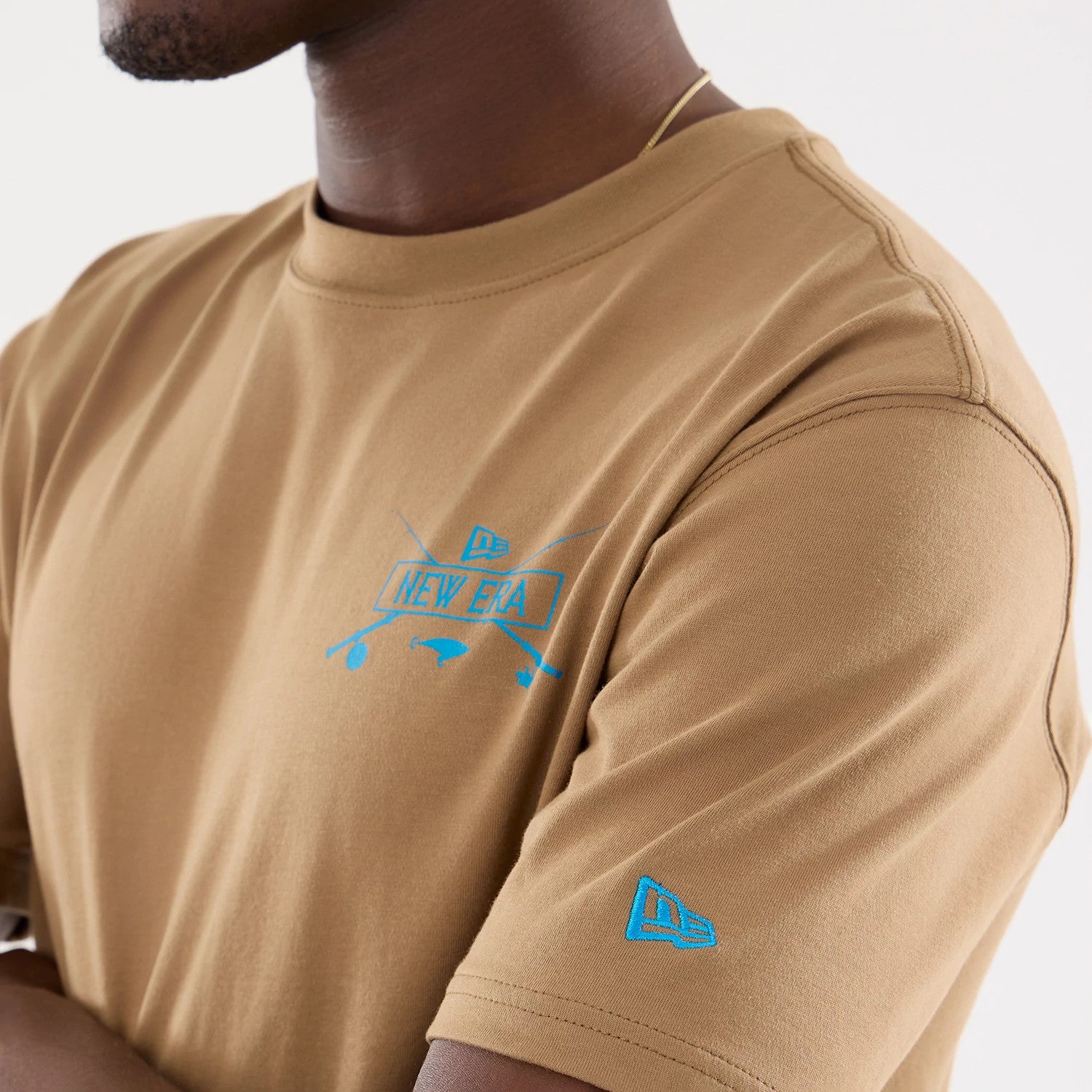 The model is wearing this New Era Outdoor Fishing T-Shirt in Beige. 3