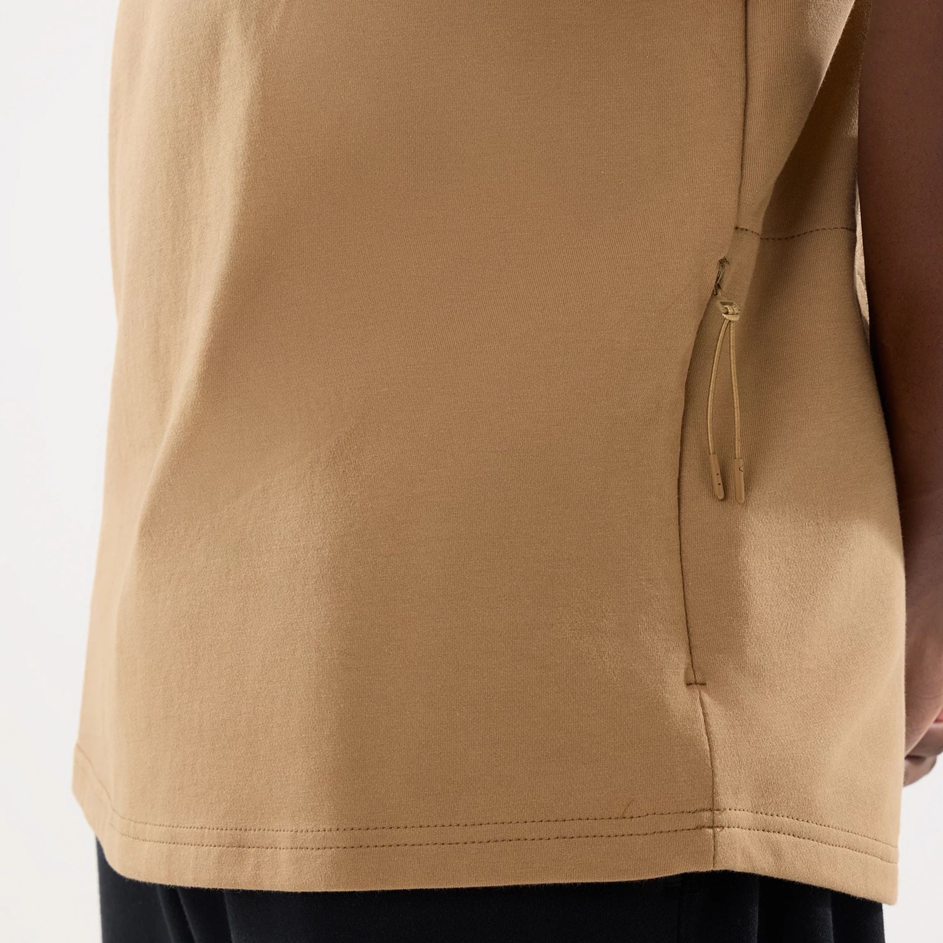 The model is wearing this New Era Outdoor Fishing T-Shirt in Beige. 7