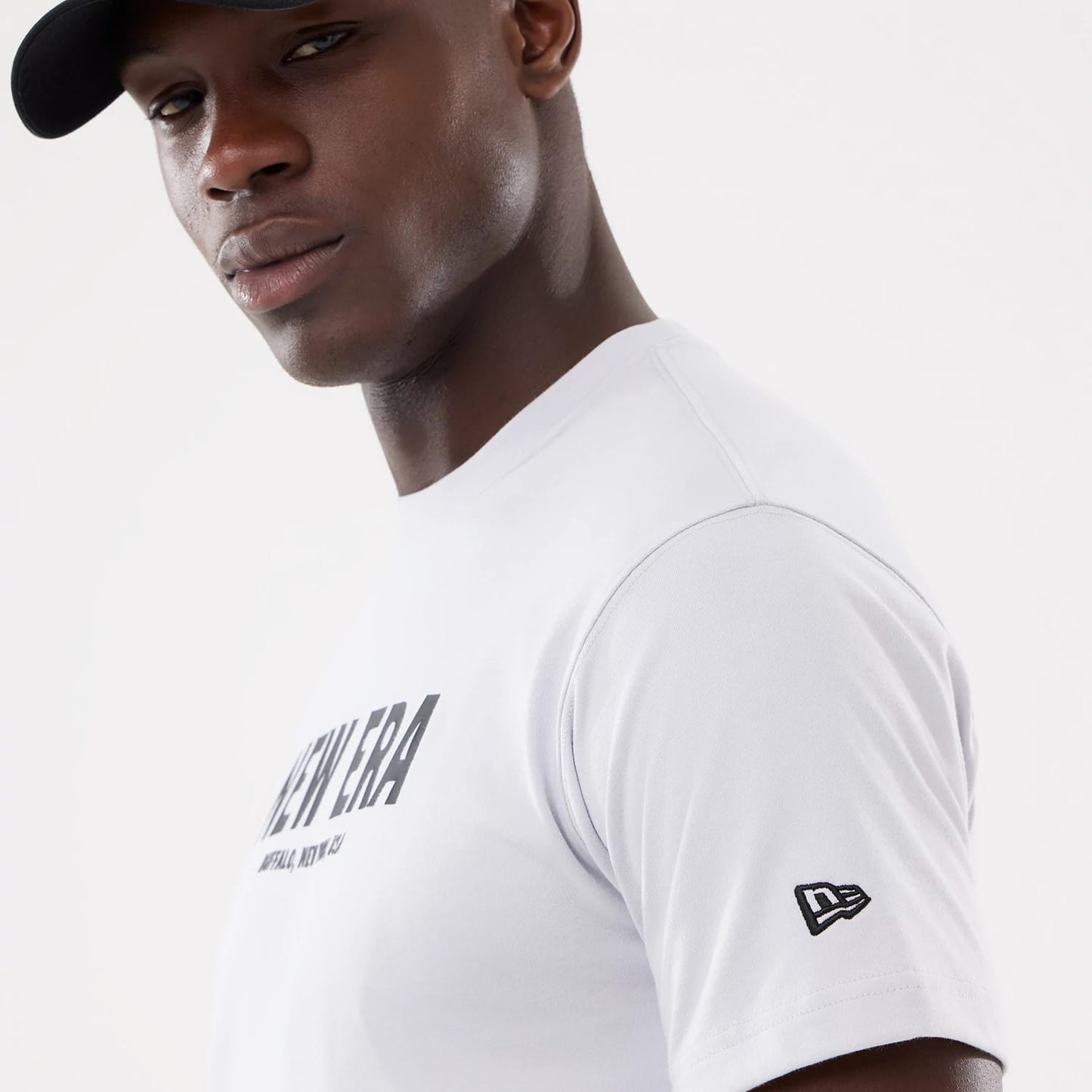 The model is wearing this New Era Basic T-Shirt in white. 4