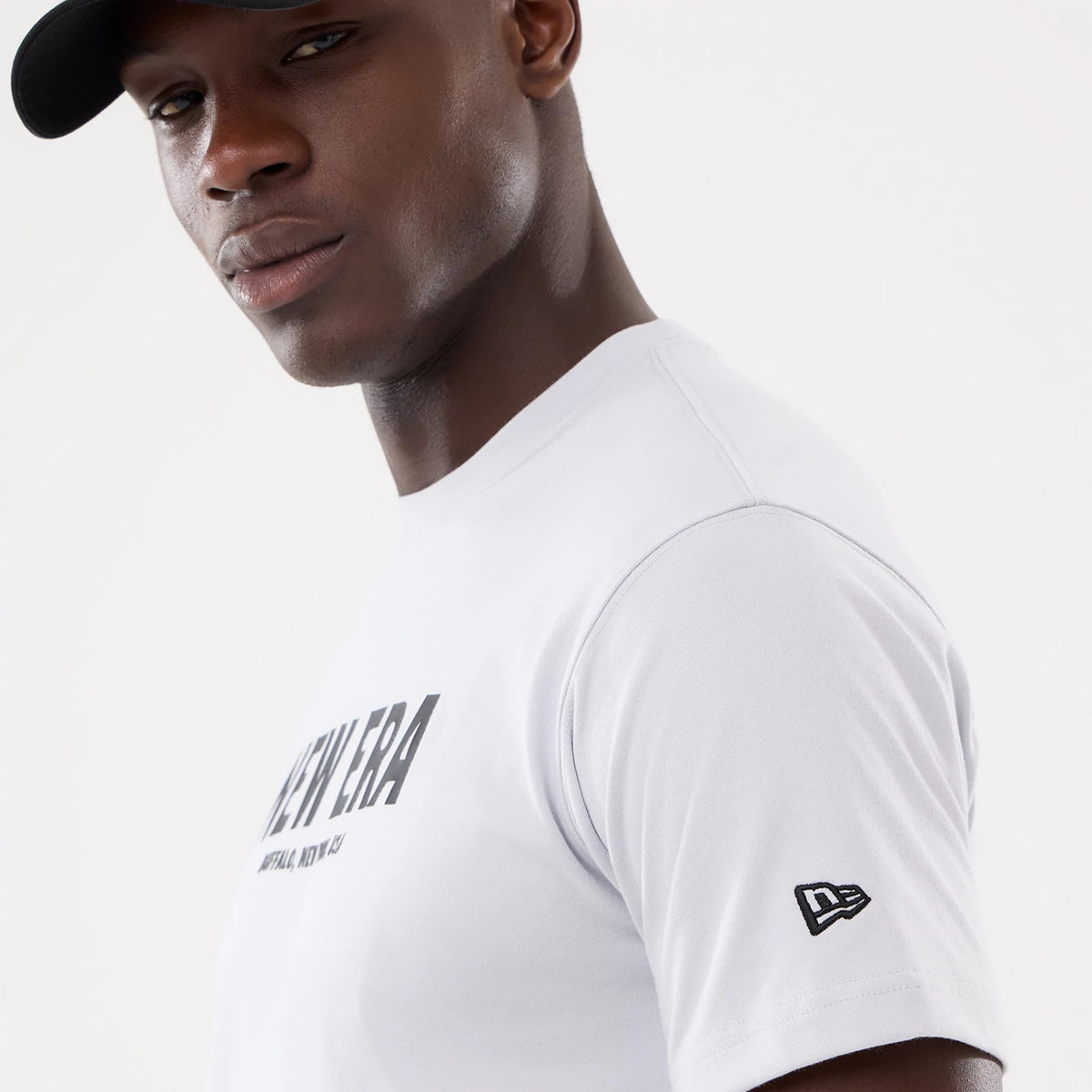 The model is wearing this New Era Basic T-Shirt in white. 4