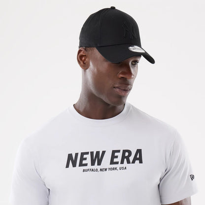 The model is wearing this New Era Basic T-Shirt in white. 6