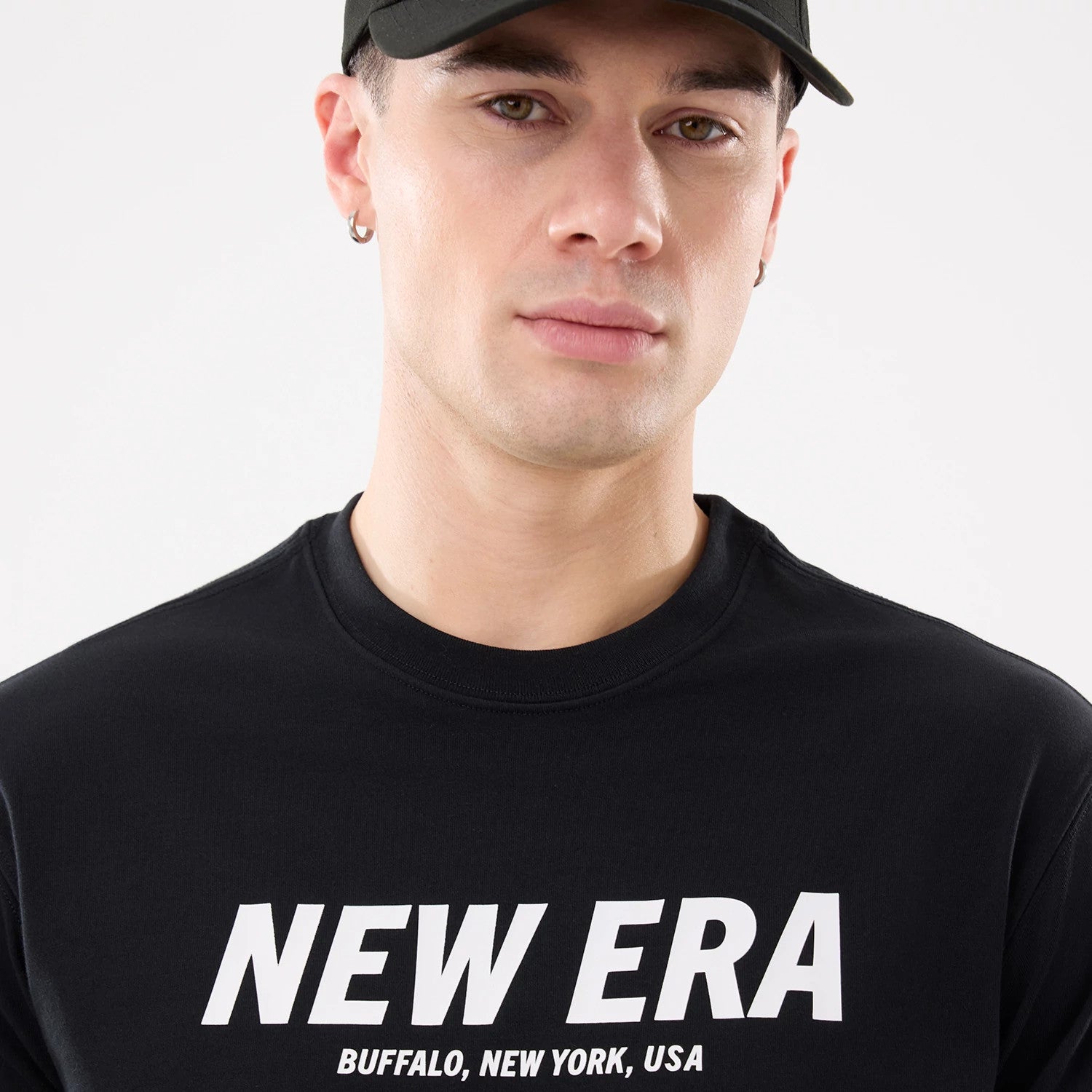 The model is wearing this New Era Basic T-Shirt in black. 4