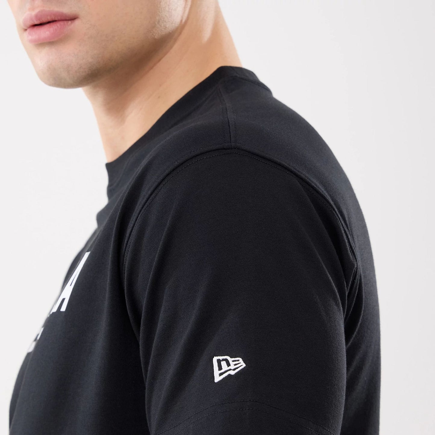 The model is wearing this New Era Basic T-Shirt in black. 5