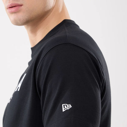 The model is wearing this New Era Basic T-Shirt in black. 5