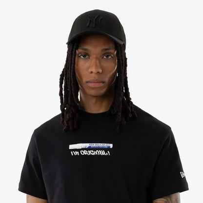 The model is wearing this New Era I Am Original T-Shirt in black. 6