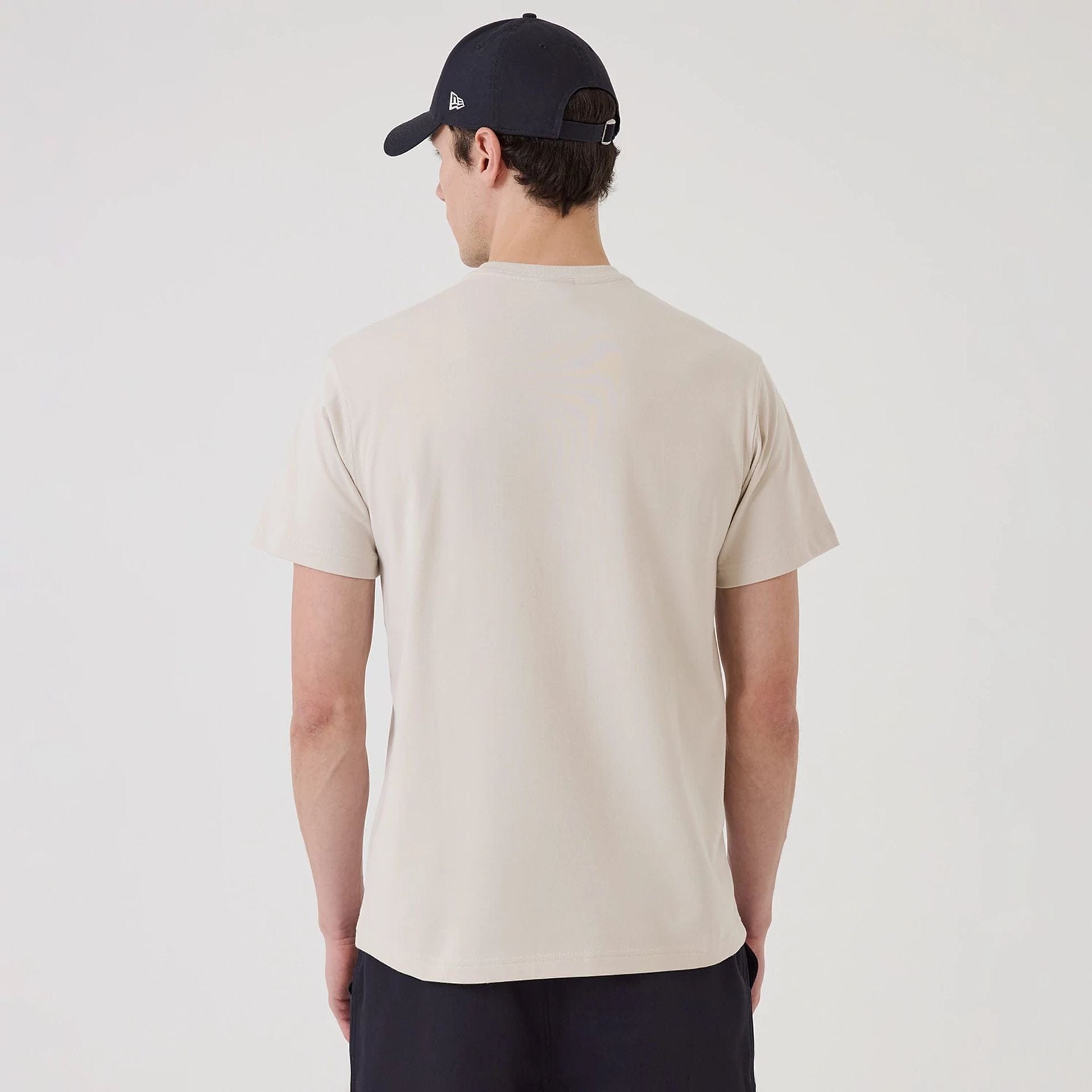 The model is wearing this New Era SK8 Graphic T-Shirt in Cream. 2