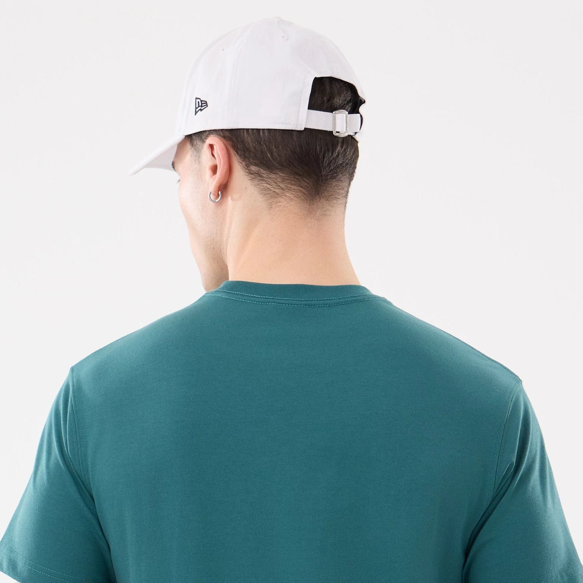 The model is wearing this New Era SK8 Graphic T-Shirt in dark green. 6