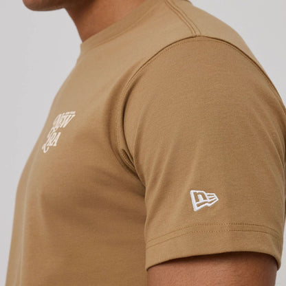 The model is wearing this New Era Script Graphic T-Shirt in Beige. 6